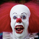 Tim Curry as Pennywise the Clown in the 1990 miniseries It, baring his teeth.